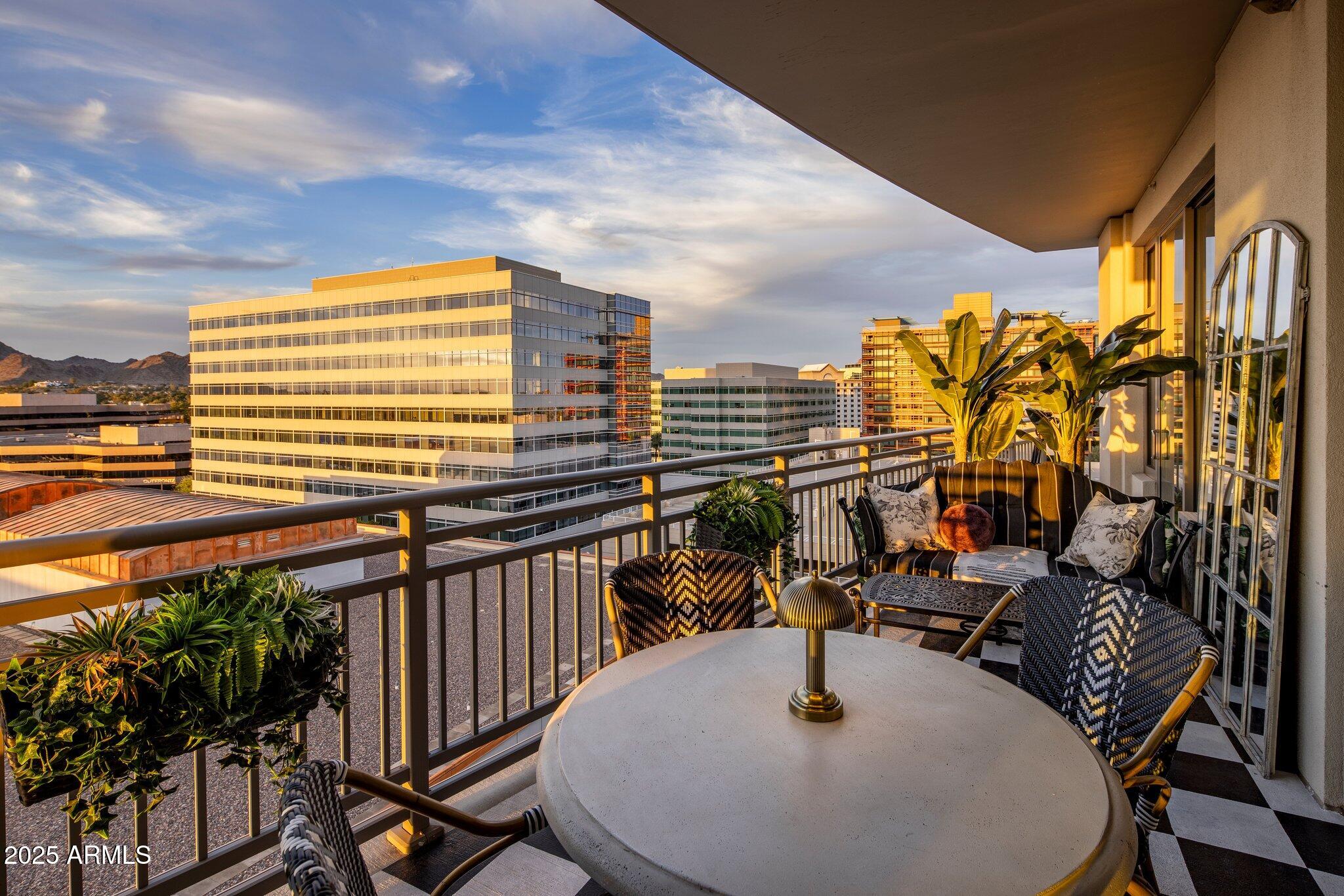 2211 East Camelback Road, Unit 902 Phoenix, AZ 85016 - Photo 35 of 37 a balcony with table and chairs