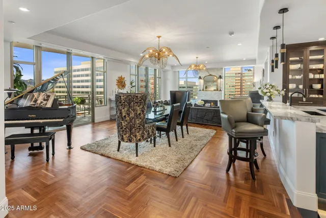 a view of a a dining room with furniture window and wooden floor