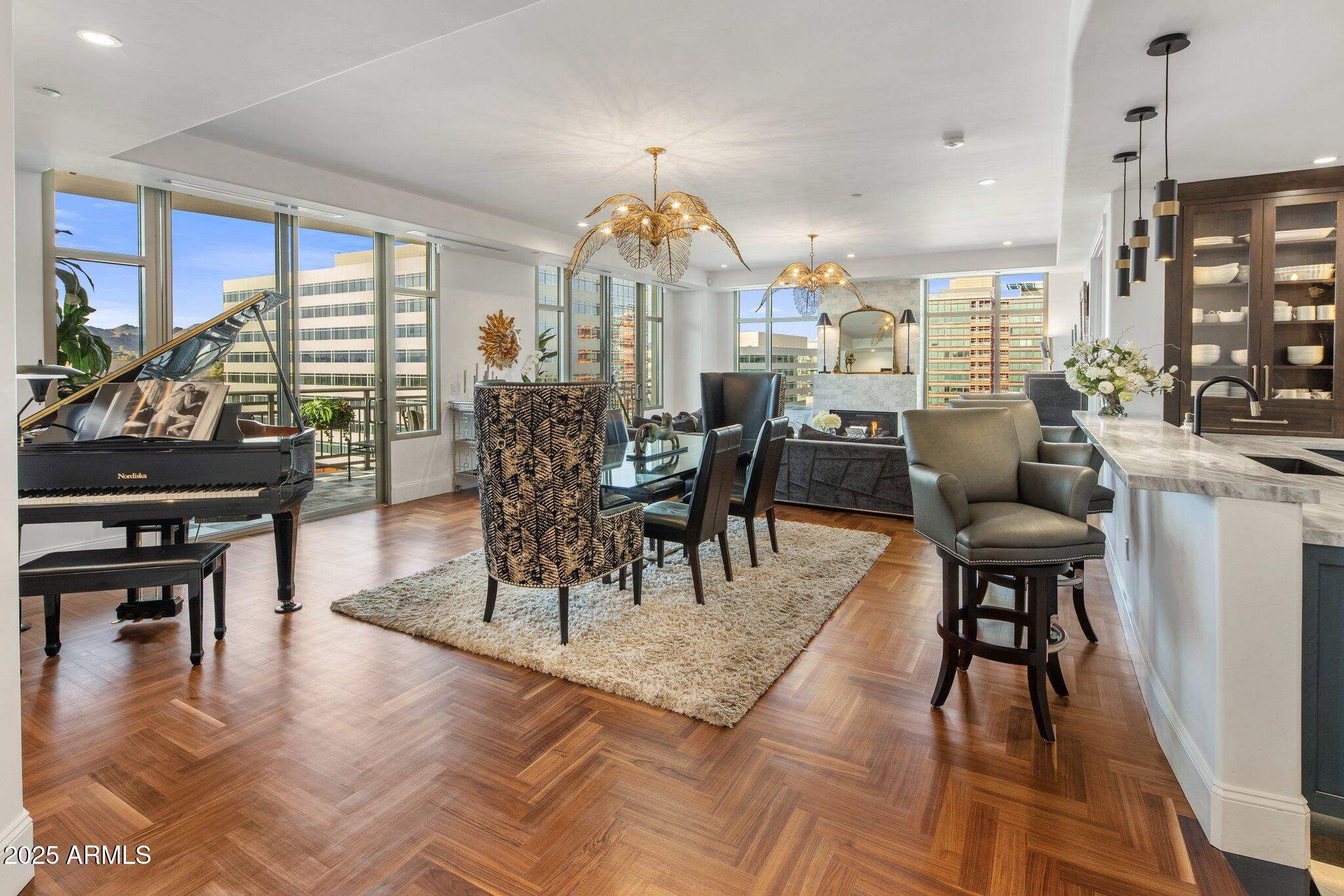 2211 East Camelback Road, Unit 902 Phoenix, AZ 85016 - Photo 4 of 37 a view of a a dining room with furniture window and wooden floor