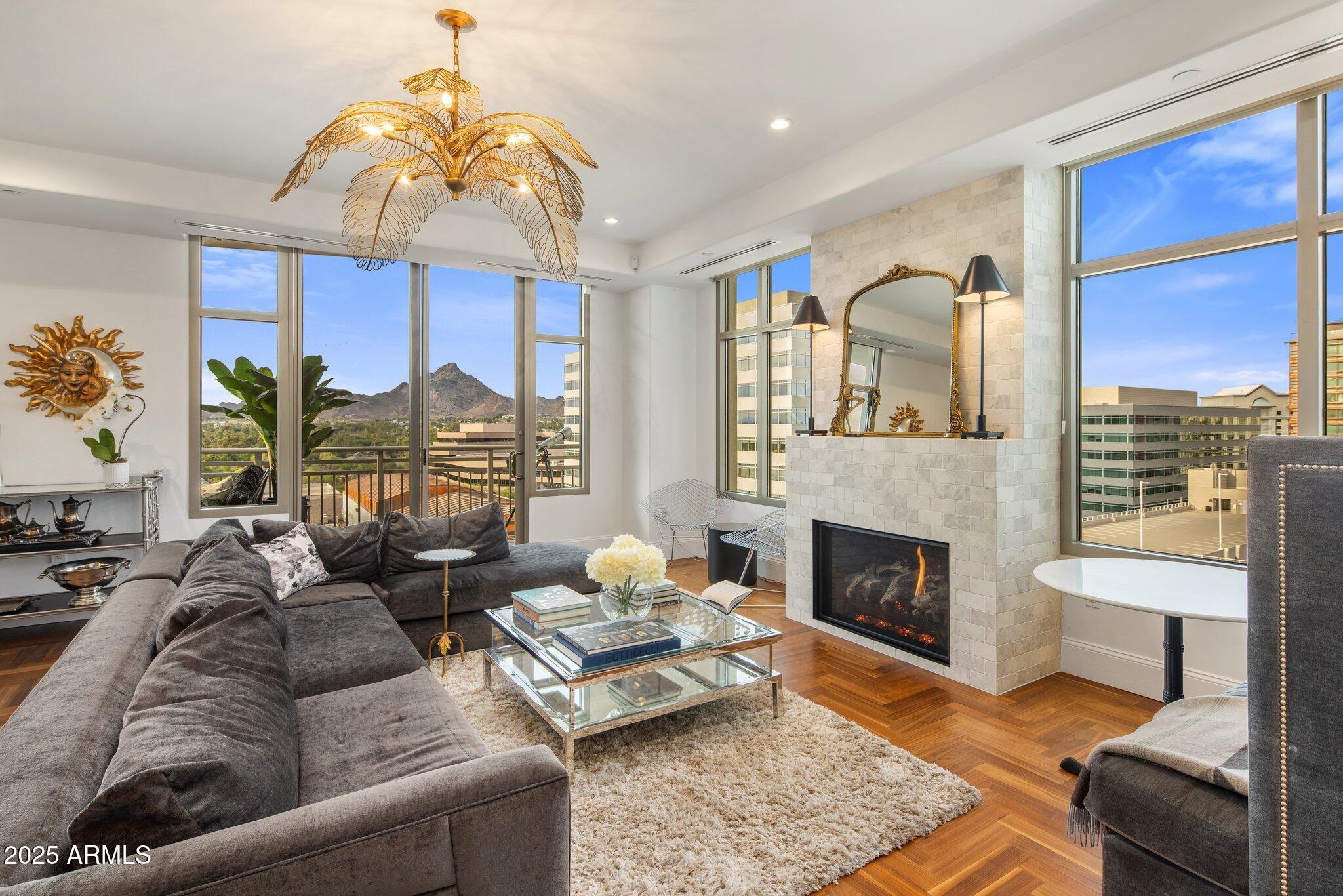 2211 East Camelback Road, Unit 902 Phoenix, AZ 85016 - Photo 7 of 37 a living room with furniture fireplace and a fireplace