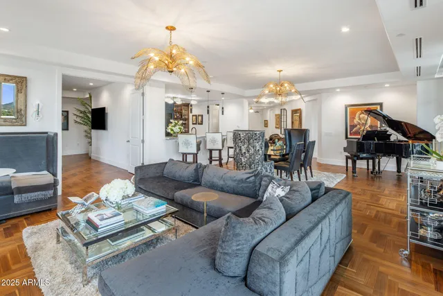 a living room with furniture and a chandelier
