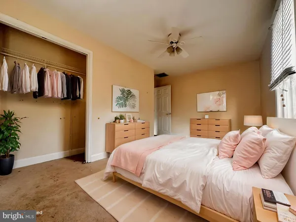 an empty room with windows and chandelier fan
