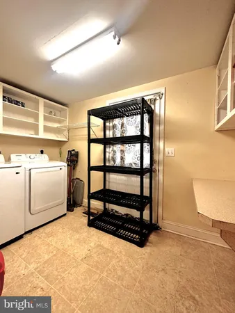 a bathroom with a granite countertop toilet sink and mirror