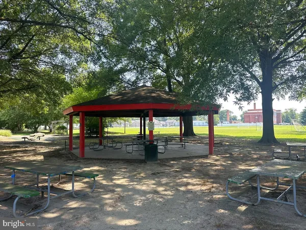 a backyard of a house with lots of green space and fountain