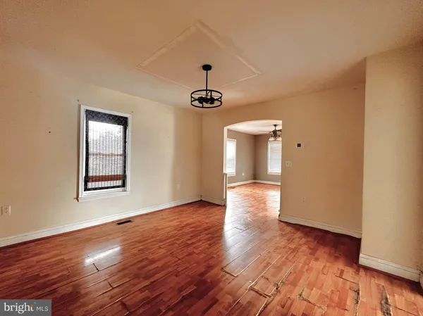 a large kitchen with stainless steel appliances granite countertop a sink a stove a refrigerator cabinets and a window