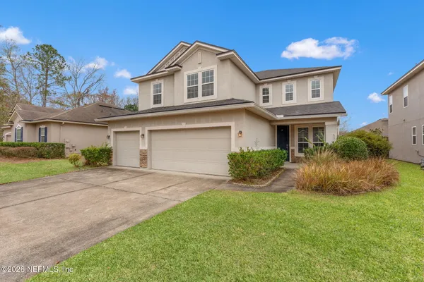 a front view of a house with a yard and garage