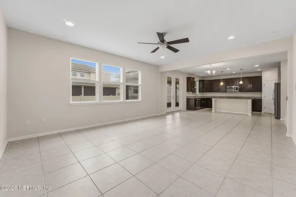 a kitchen with stainless steel appliances granite countertop a refrigerator a sink a stove a microwave and island