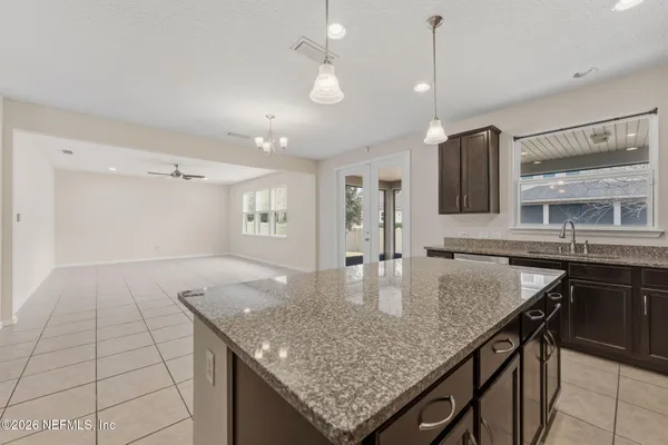 a kitchen with stainless steel appliances granite countertop a sink and stove