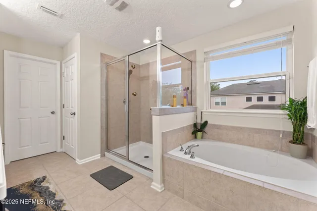 a white bath tub sitting next to a bathroom