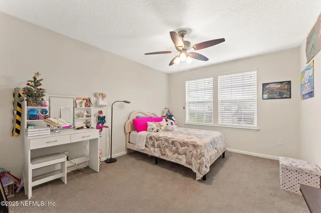 a bedroom with a bed dresser and a window
