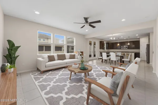 a living room with furniture and a view of kitchen