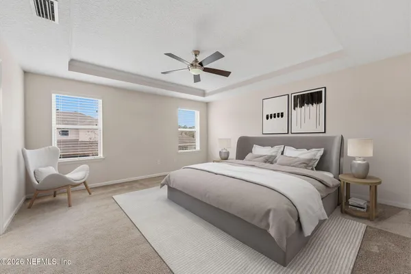 an empty room with chandelier fan and windows