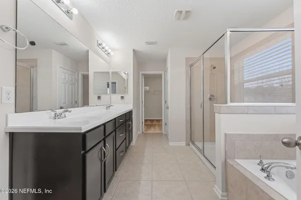 a bathroom with a bathtub and a shower
