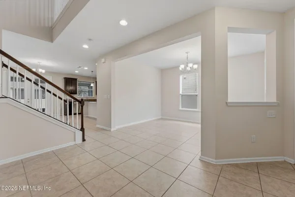 a view of staircase with lots of frames and a rug