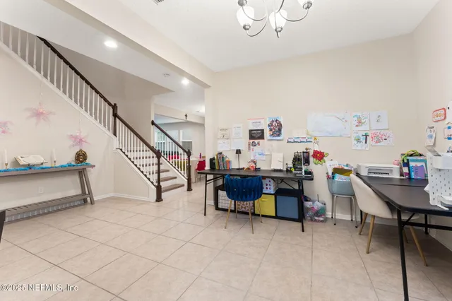a view of a room with lots of furniture and wooden floor