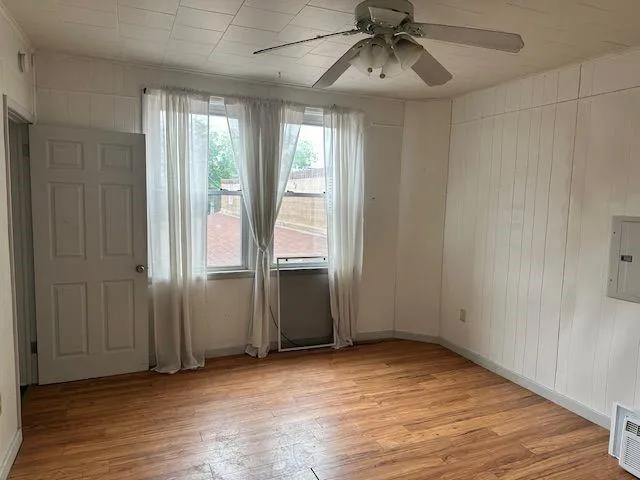 a view of a room with wooden floor and furniture