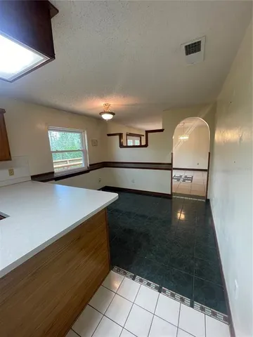 a view of kitchen with a sink stove and cabinets