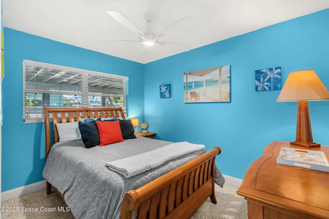 a bedroom with a bed and a lamp on table