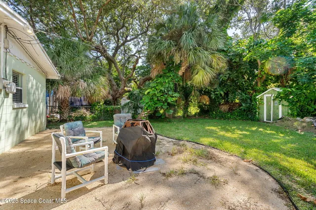 a view of backyard with seating area and green space