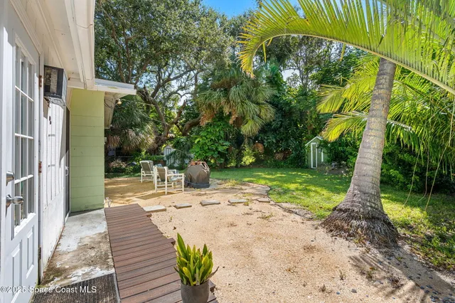 a view of a backyard with sitting area