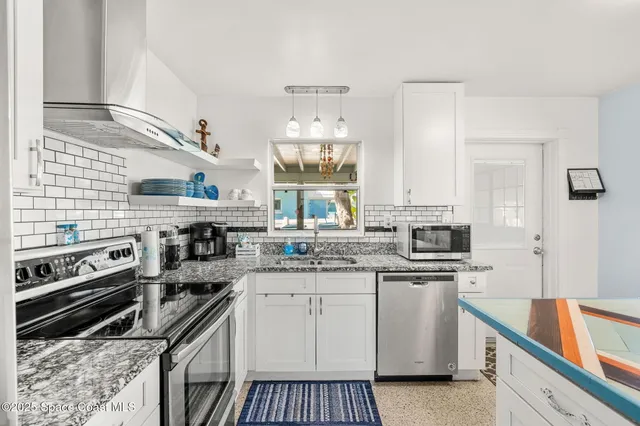 a kitchen with a sink stove top oven and cabinets