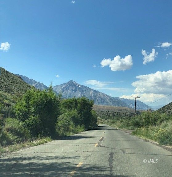 3580 Whitney Portal Road Lone Pine, CA 93545 - Photo 13 of 32 a view of a pathway both side of grassy field with trees