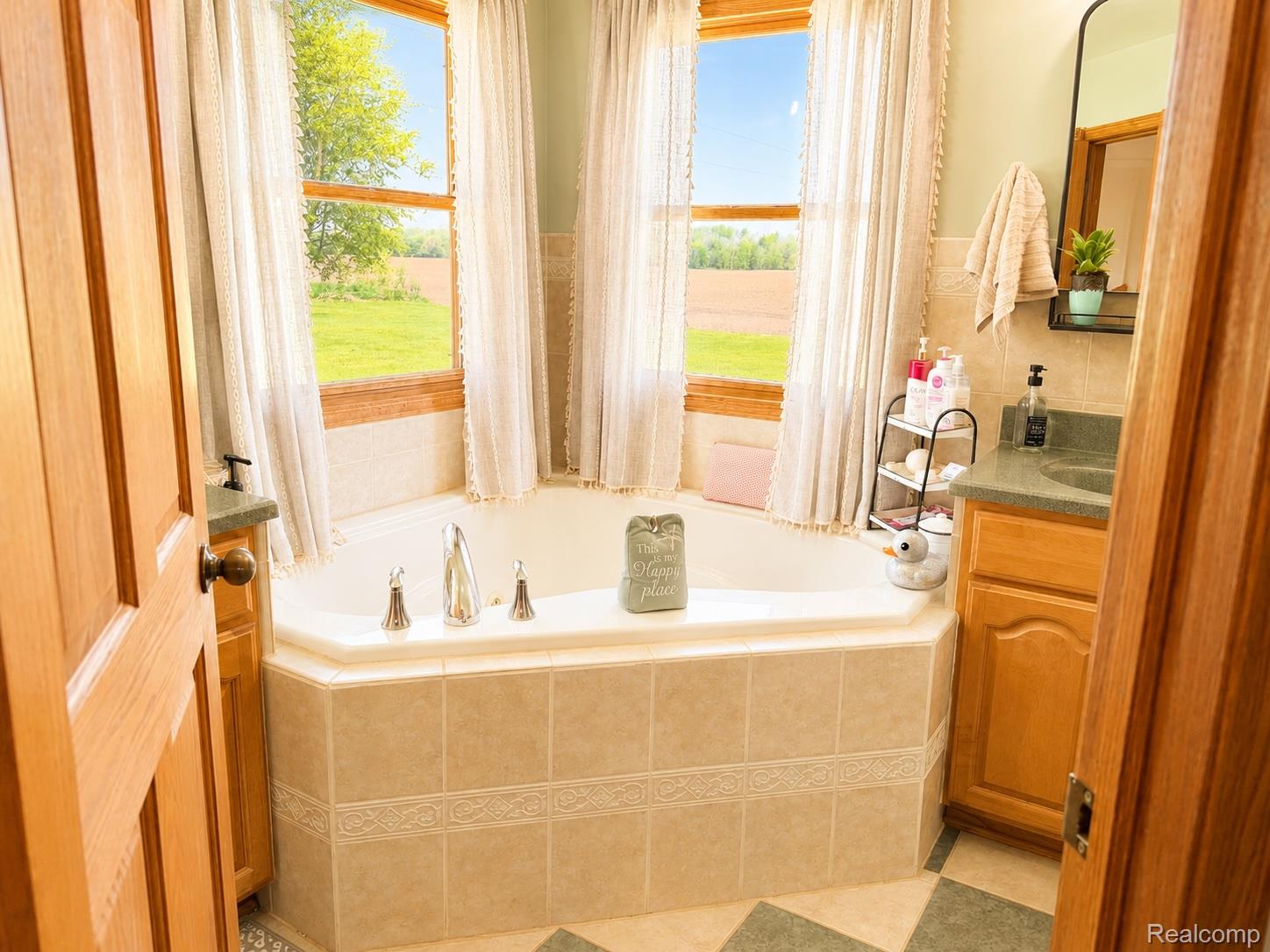 6860 Grand River Road Bancroft, MI 48414 - Photo 16 of 31 Full bath featuring a garden tub and vanity