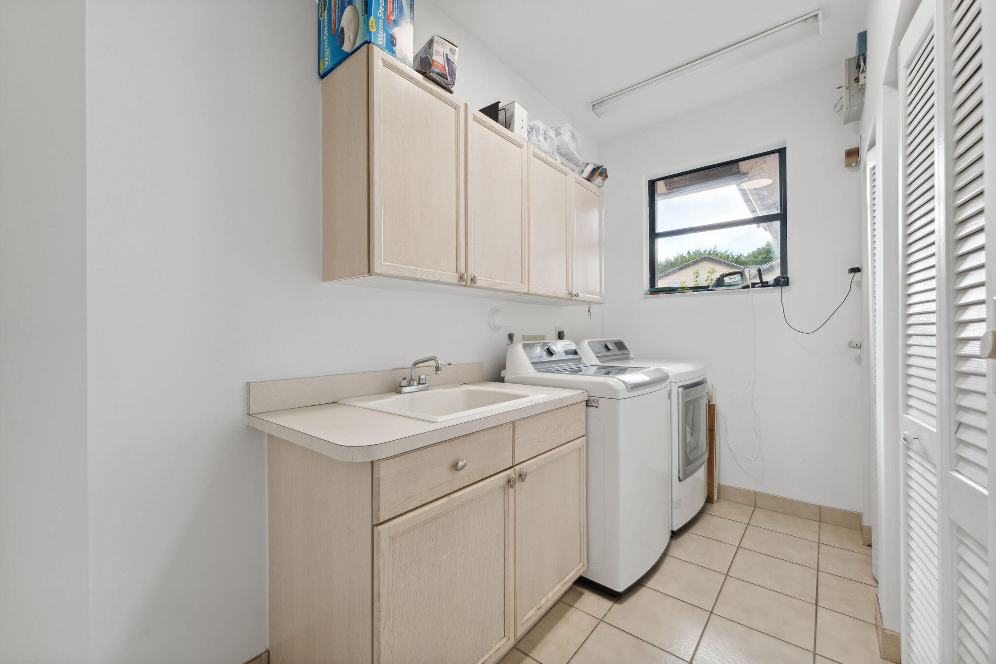 7726 La Corniche Circle Boca Raton, FL 33433 - Photo 16 of 27 a view of a bathroom with a sink and a mirror