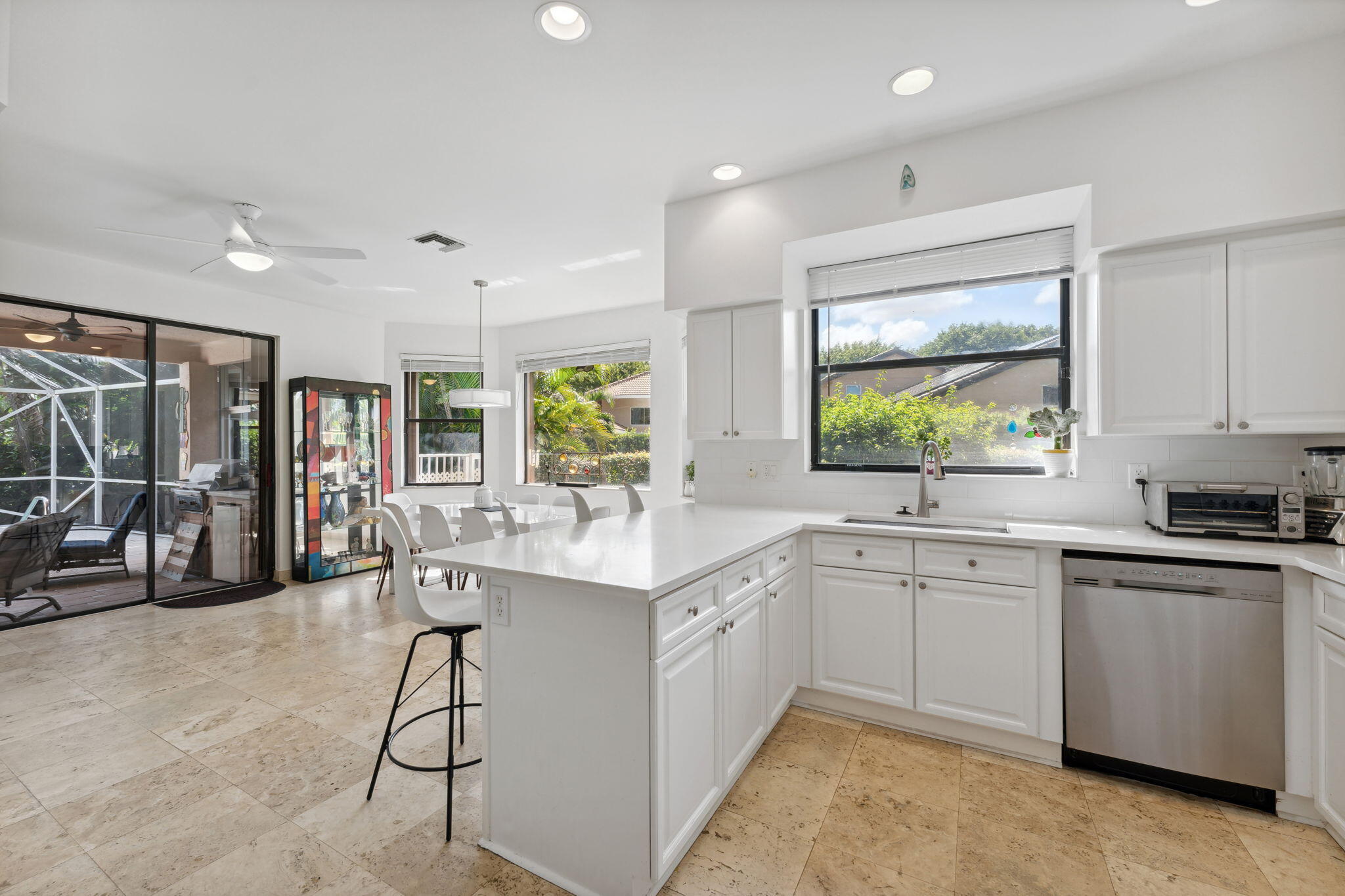 7726 La Corniche Circle Boca Raton, FL 33433 - Photo 19 of 27 a kitchen with a sink window and cabinets