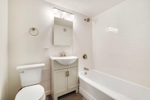 a bathroom with a sink a toilet and bathtub