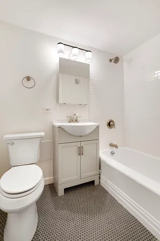 a bathroom with a sink a toilet and bathtub