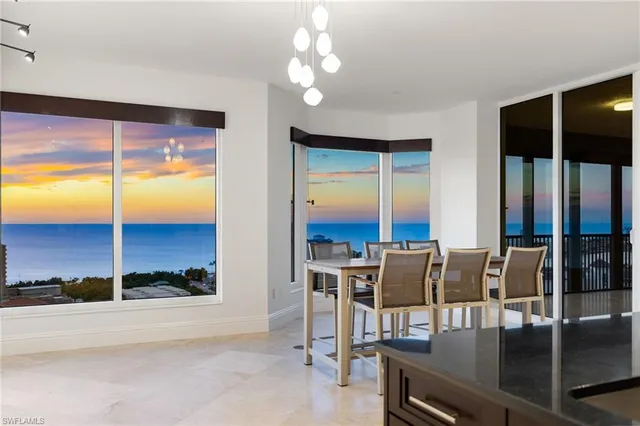 a view of a dining room with furniture window and outside view
