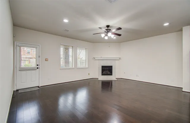 wooden floor in an empty room with a fireplace