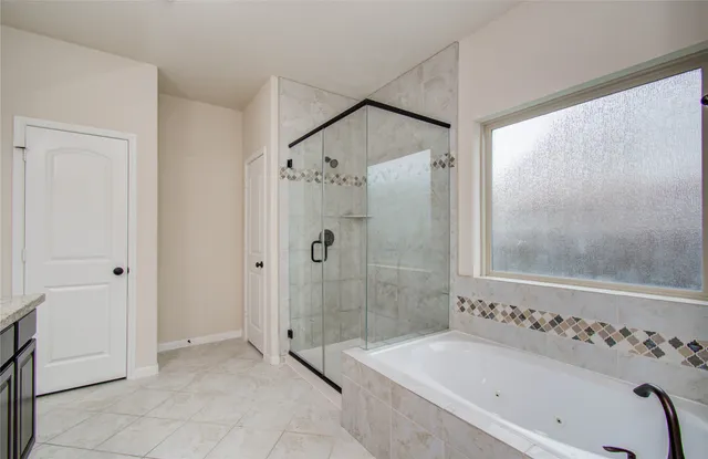 a bathroom with a bathtub and a shower