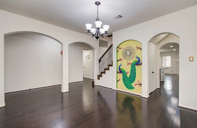 a view of an entryway with wooden floor a mirror