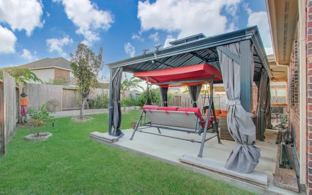 a view of a backyard with a patio and fire pit