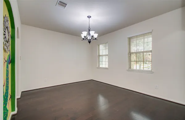 a view of an entryway with wooden floor a mirror