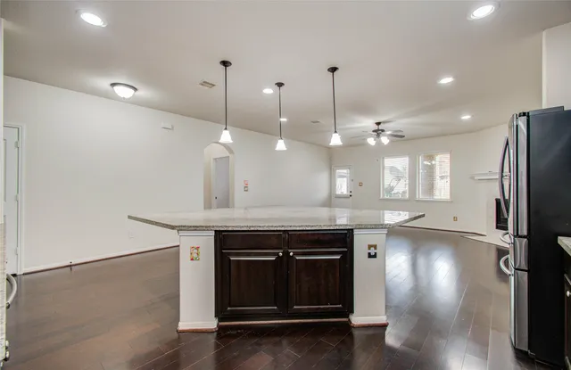 a view of a kitchen with a sink and refrigerator