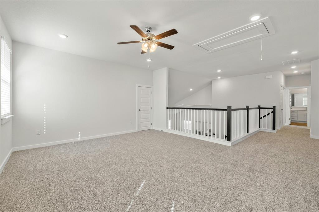 113 Shadow Oak Cove Georgetown, TX 78628 - Photo 27 of 40 A well-lit loft area provides flexible living space with carpet flooring and recessed lighting.