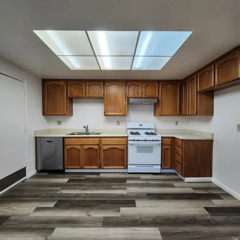 a kitchen with stainless steel appliances granite countertop a stove and a sink