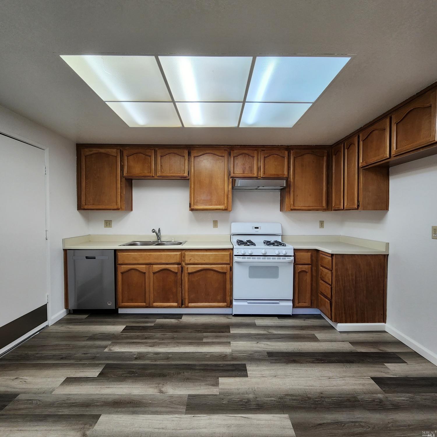 a kitchen with stainless steel appliances granite countertop a stove and a sink