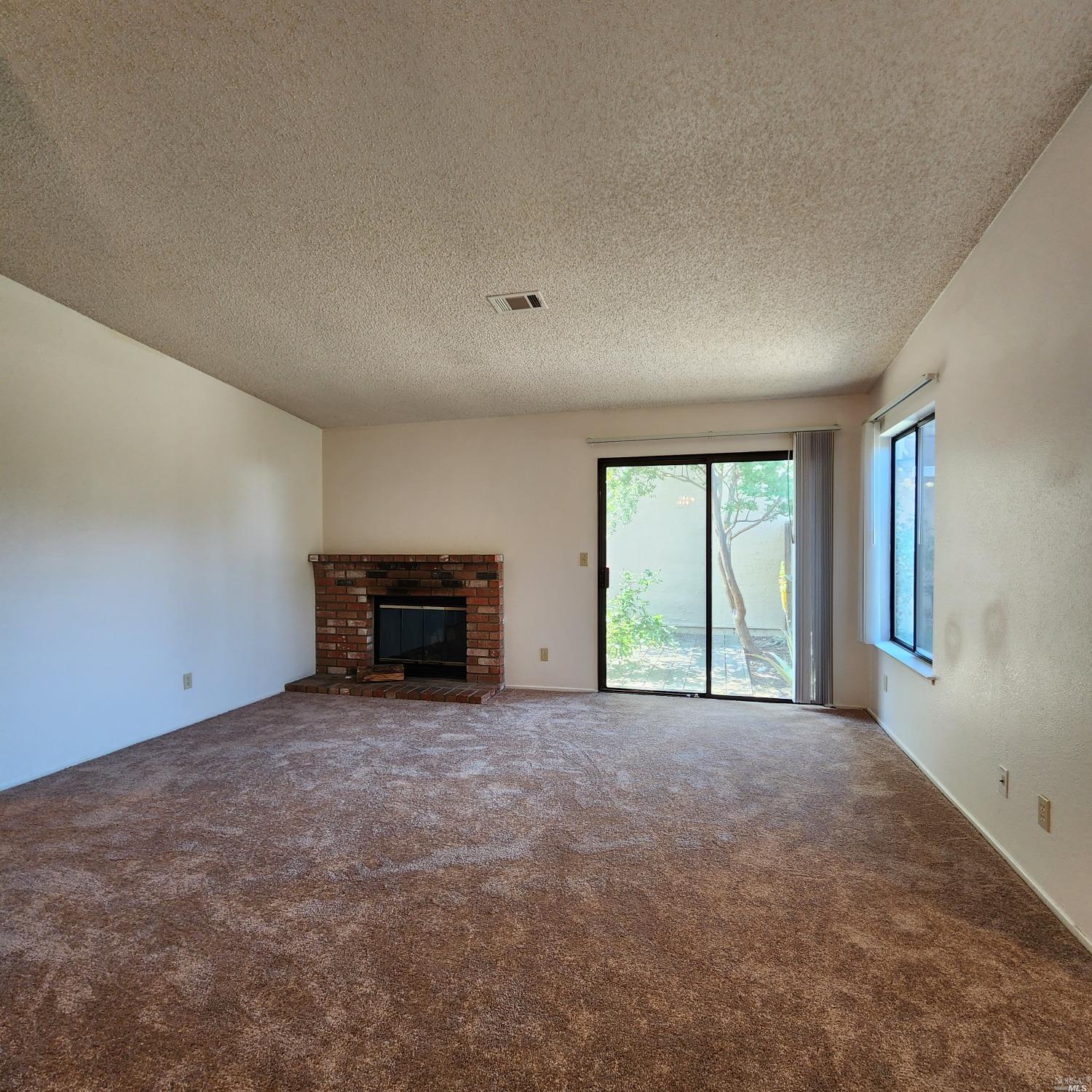 1024 Scott Street Fairfield, CA 94533 - Photo 4 of 9 an empty room with windows and fireplace