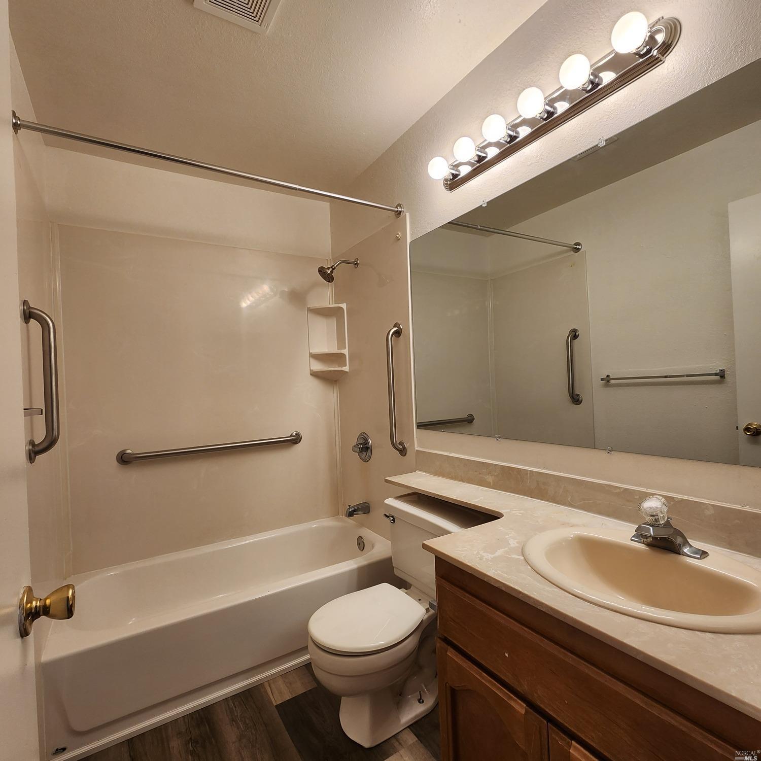 1024 Scott Street Fairfield, CA 94533 - Photo 5 of 9 a bathroom with a sink a toilet a mirror and shower