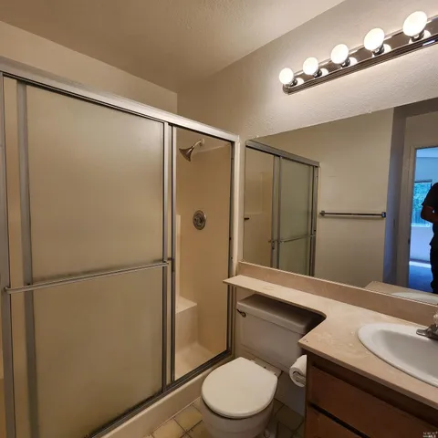 a bathroom with a toilet a sink and shower