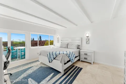 a bedroom with a bed lamp and window