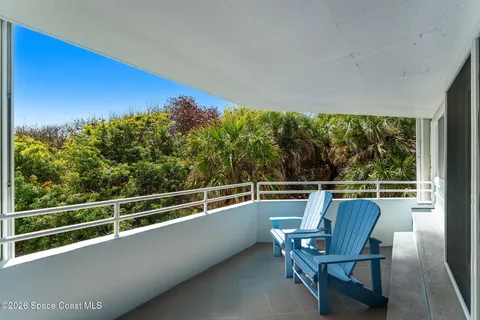 a view of a chairs and table in patio