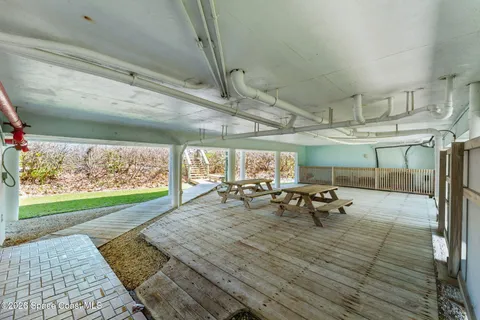 a view of a patio with table and chairs with wooden floor and outdoor space