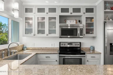 a kitchen with stainless steel appliances granite countertop a stove and a sink