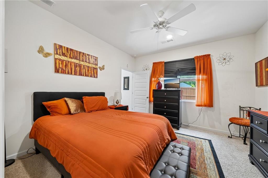 8592 Seabiscuit Road Lithonia, GA 30058 - Photo 9 of 25 a bedroom with a bed and a chandelier