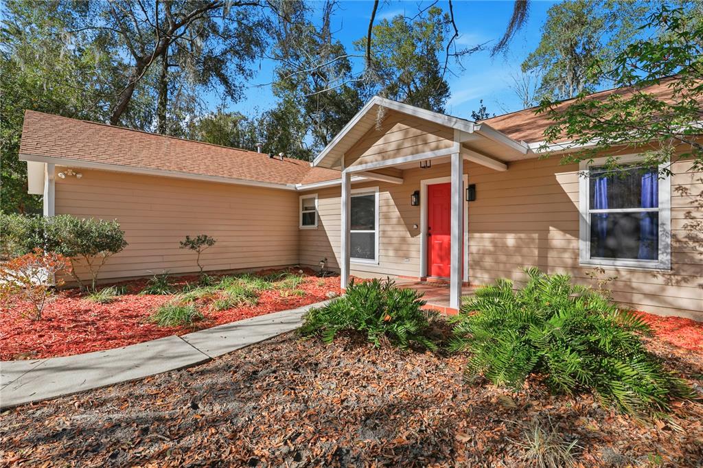 8006 Southwest 62 Lane Gainesville, FL 32608 - Photo 17 of 17 a front view of a house with lots of garden